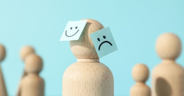 A wooden figure with sticky note surrounded by other wooden figures, visually represents rare mental disorders