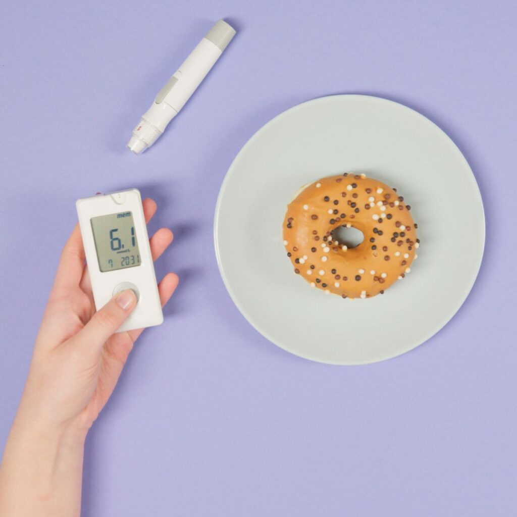 Blood glucose check before eating donut for nutrition monitoring